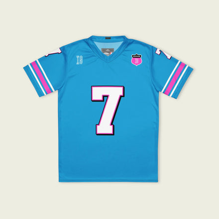 A blue and pink football jersey with Jack Doohan's Alpine F1 Racing number 7 on the front and back in white with a pink and black outline.