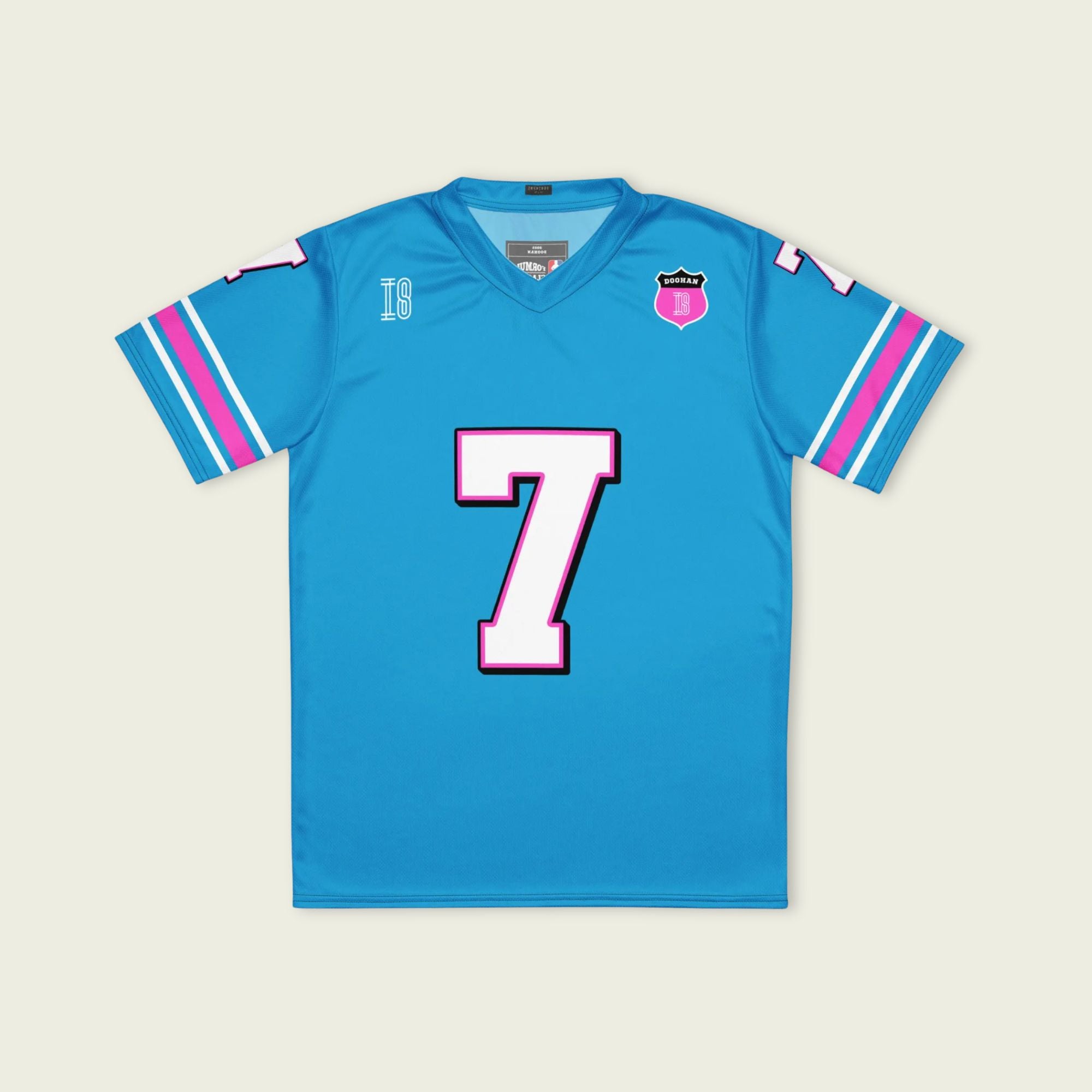 A blue and pink football jersey with Jack Doohan's Alpine F1 Racing number 7 on the front and back in white with a pink and black outline.