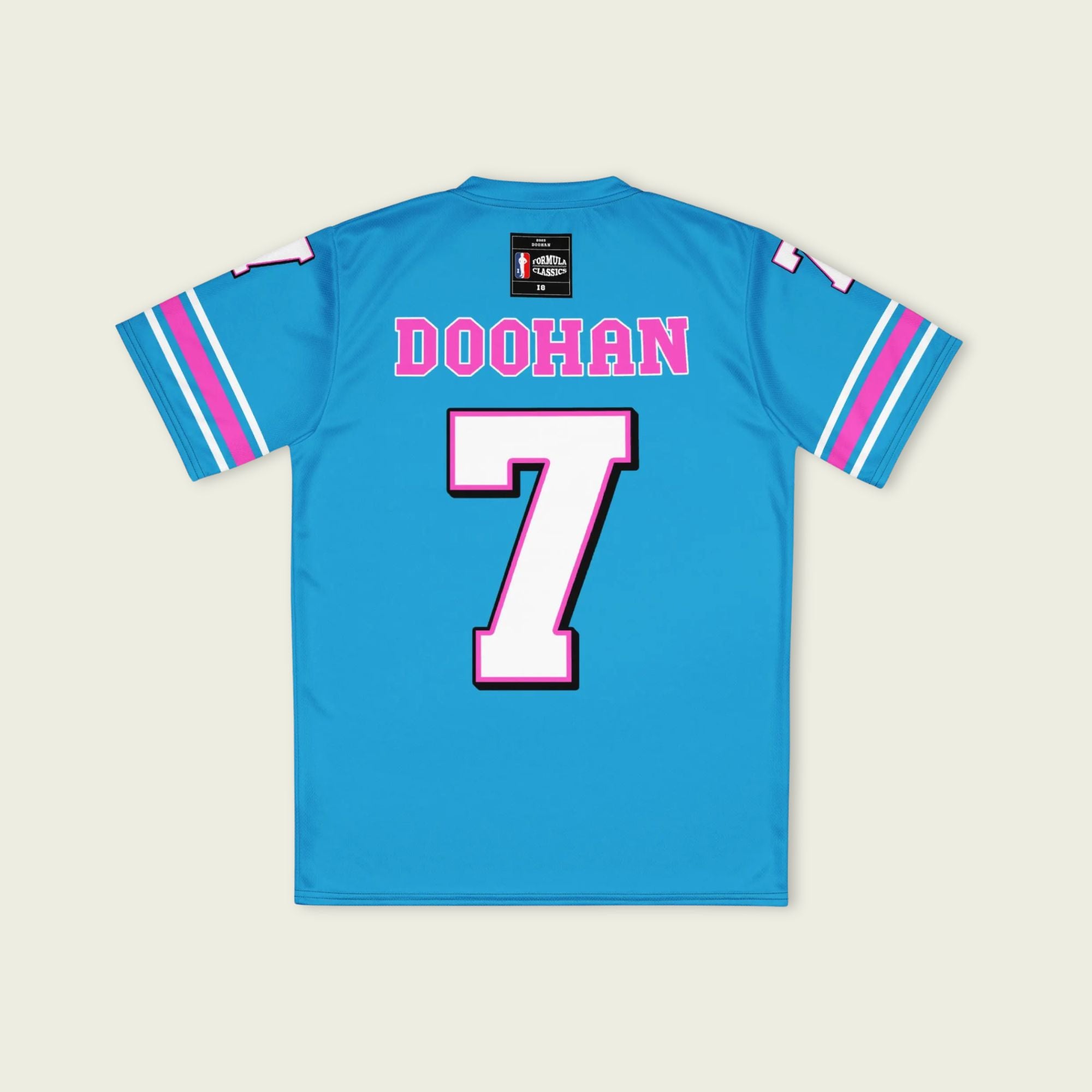 A blue and pink football jersey with Jack Doohan's Alpine F1 Racing number 7 on the front and back in white with a pink and black outline.