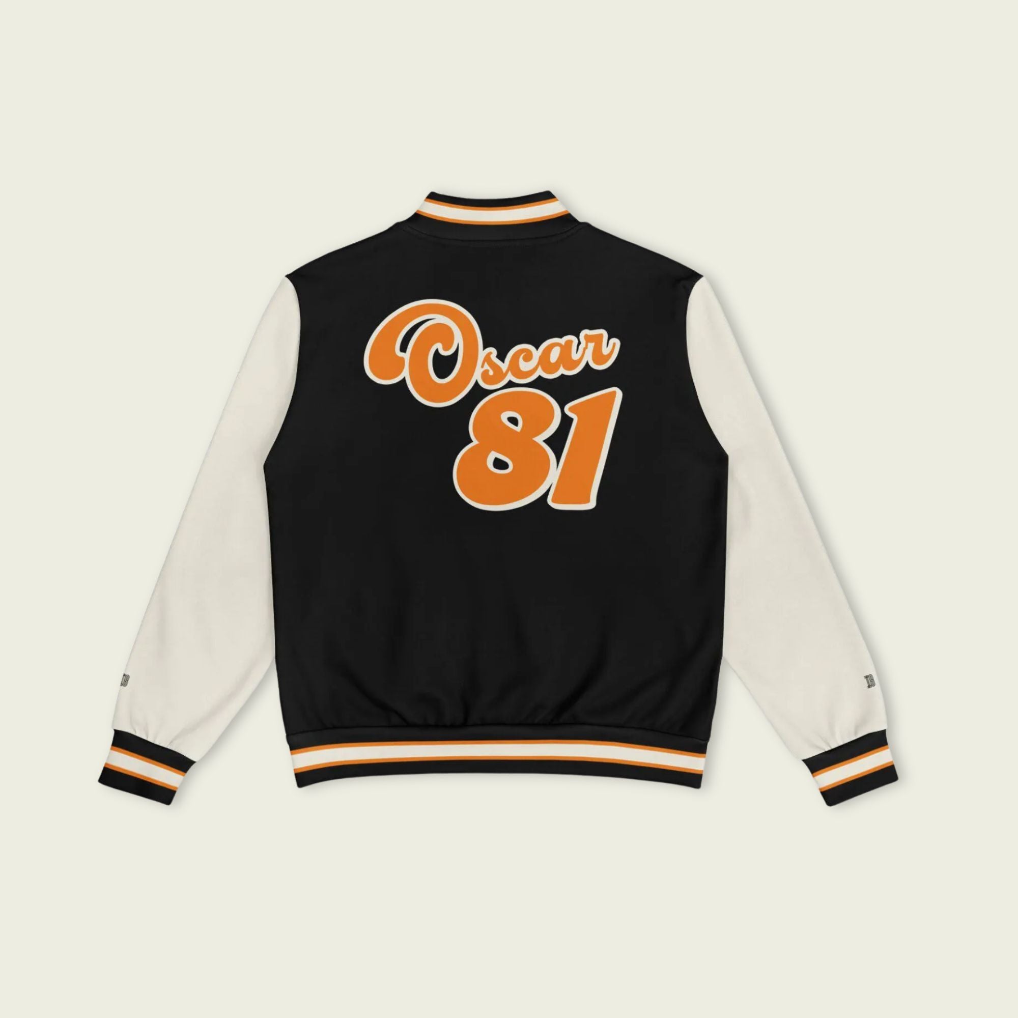 A black, papaya orange, and tan, varsity jacket with Oscar Piastri's McLaren F1 racing number 81 in orange on the front and back.