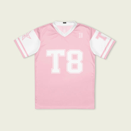 A pink and white football jersey with Tate Mcare on the back and front in white with a white  outline.