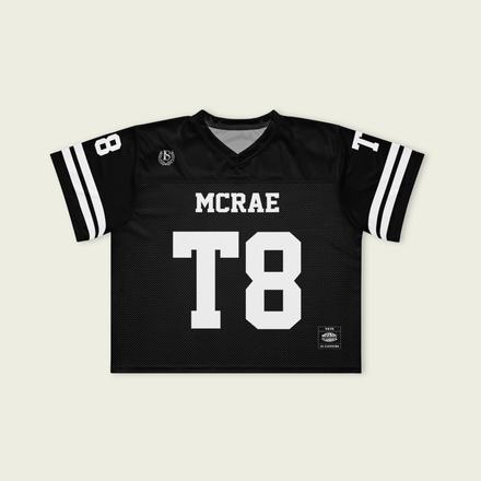 Black sports jersey with 'MCRAE' and 'T8' printed on a beige background